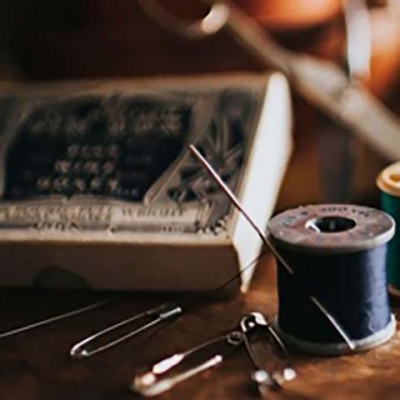 needle and thread beside bobby-pins