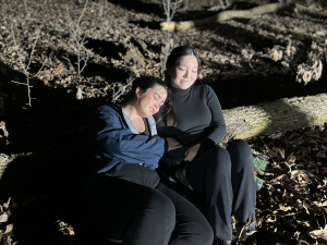 students sitting on log outside while filming hunger games scene