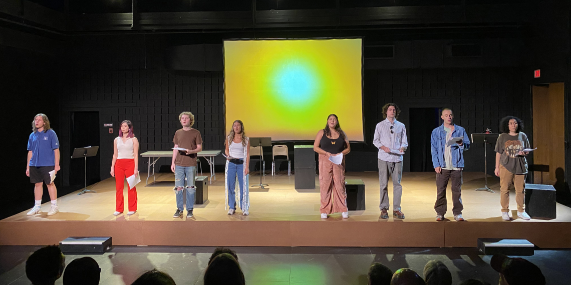 cast on stage performing staged reading 