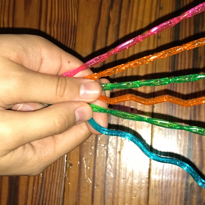 hand holding colorful sticks