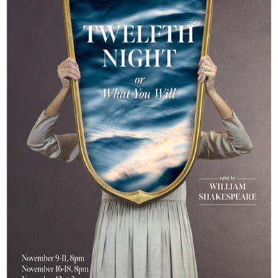 A woman in a white dress holding a mirror in front of her, on which the title "Twelfth Night" appears with a background of the sea.