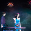 Two people on stage at a table